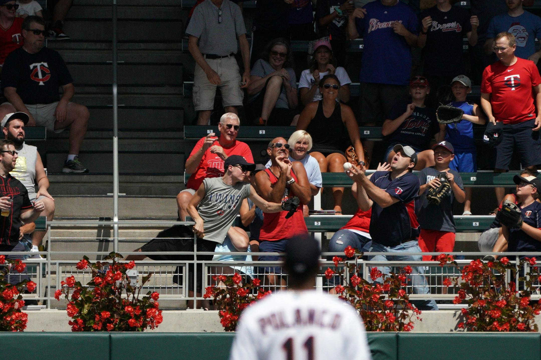 Minnesota Twins shortstop Jorge Polanco (11) watched as fans caught a solo home run hit by Atlanta Braves second baseman Ozzie Albies (1) in the sixth inning.