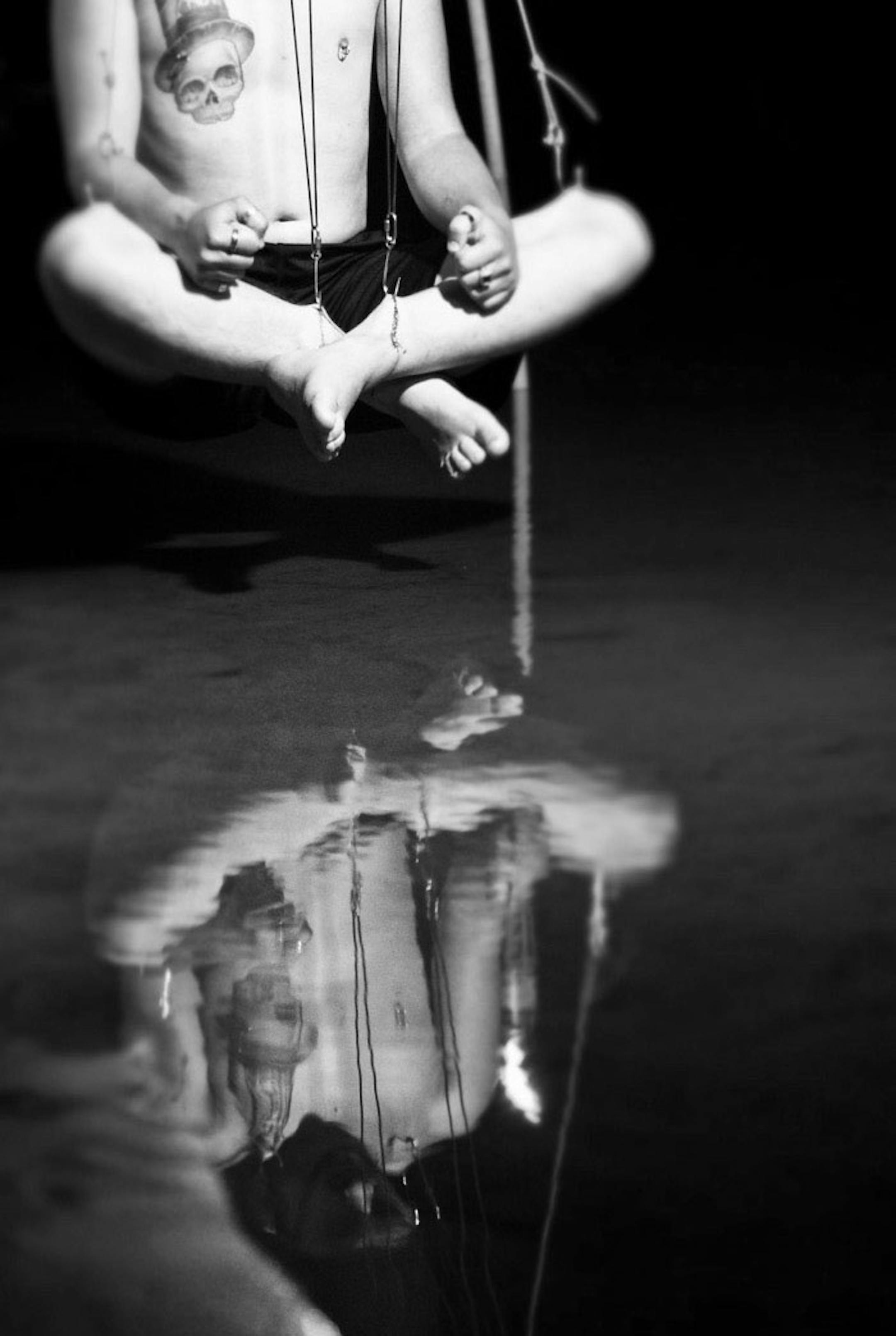 Adam Phillips of Bloomington suspended over the Mississippi River. The first time he suspended, eight years ago, he said, a “calming wave” came over him and his back pain was cured.