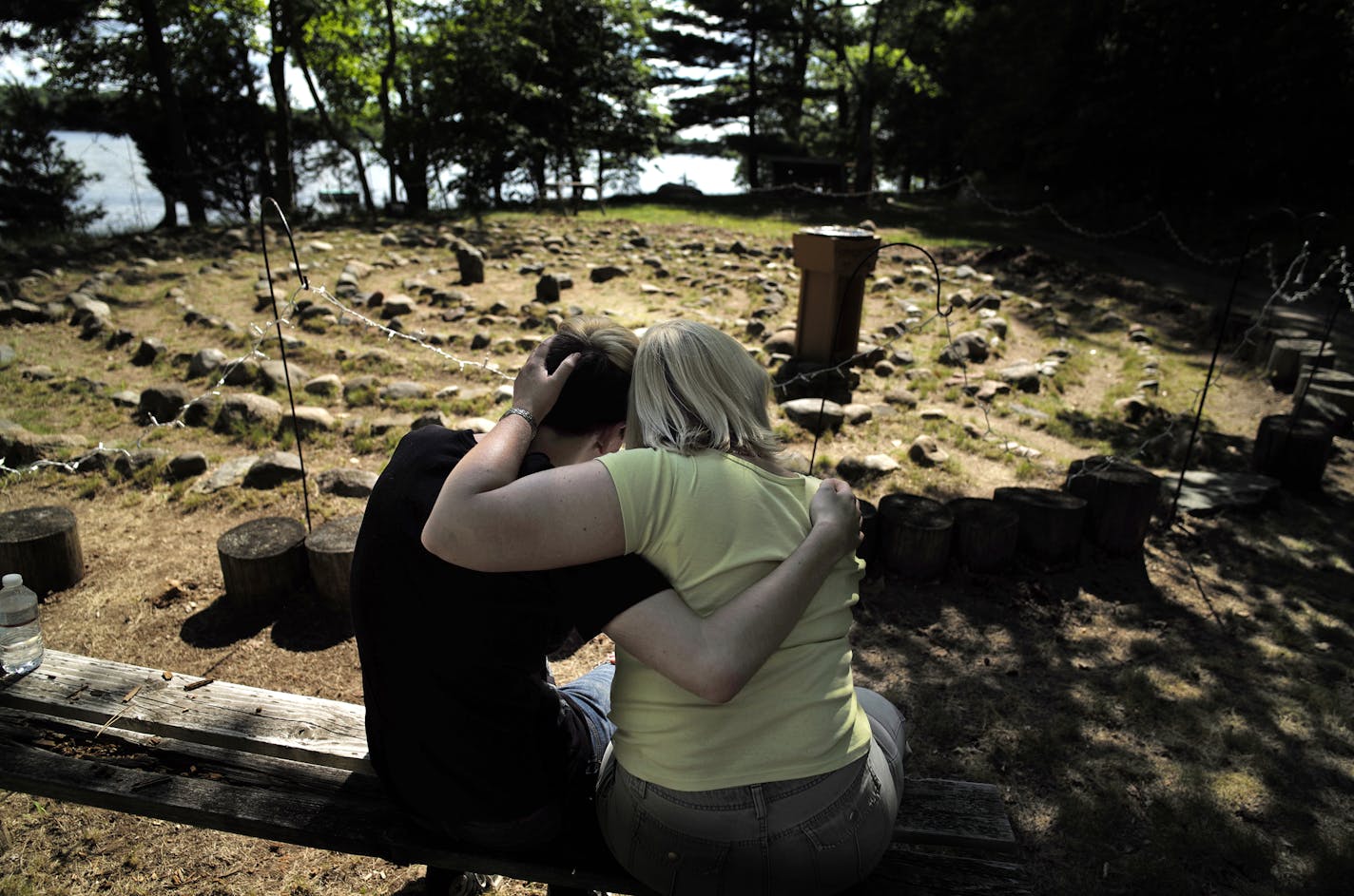 On July 23, 2014, at The Naming Project summer camp on Big Lake, Minnesota, Luke Staebler and the Rev. Susan Schneider of Madison Wisconsin hug after he went through the spiritual labyrinth that symbolizes one's unique journey to God.] Richard Tsong-Taatarii/rtsong-taatarii@startribune.com As other campers canoed, Luke Staebler walked a circular path bordered by stones, his hands clasped in front of him. The 16-year-old emerged from the labyrinth, meant to mirror the winding path to God, and joi