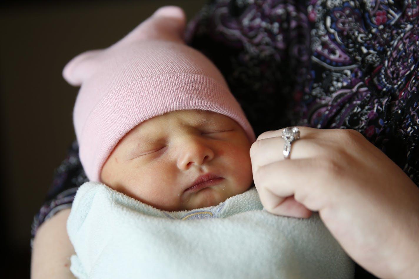 In this Thursday, May 12, 2016 photo, Jessica Bailey holds her newborn daughter Ellie Bailey after blood was collected at Community Hospital North in Indianapolis. Ellie is among some 4 million newborns in the United States who will have blood drawn this year to screen them for serious inherited diseases. (AP Photo/Michael Conroy)