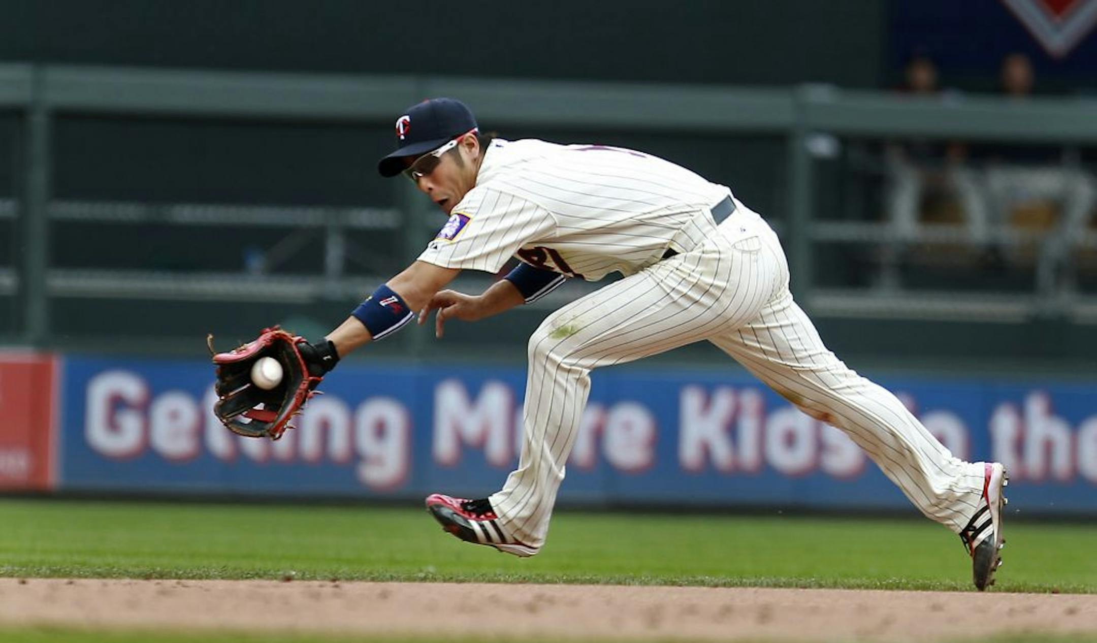 Minnesota Twins Tsuyoshi Nishioka stretched to make the catch but could not make the double play in the fourth inning.