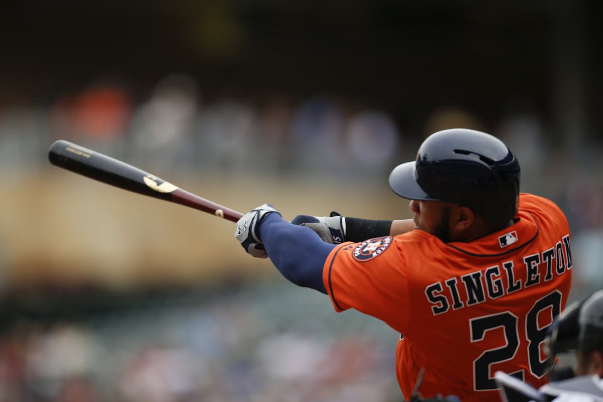 The Astros' Jon Singleton hits a ninth inning grand slam Sunday afternoon at Target Field.