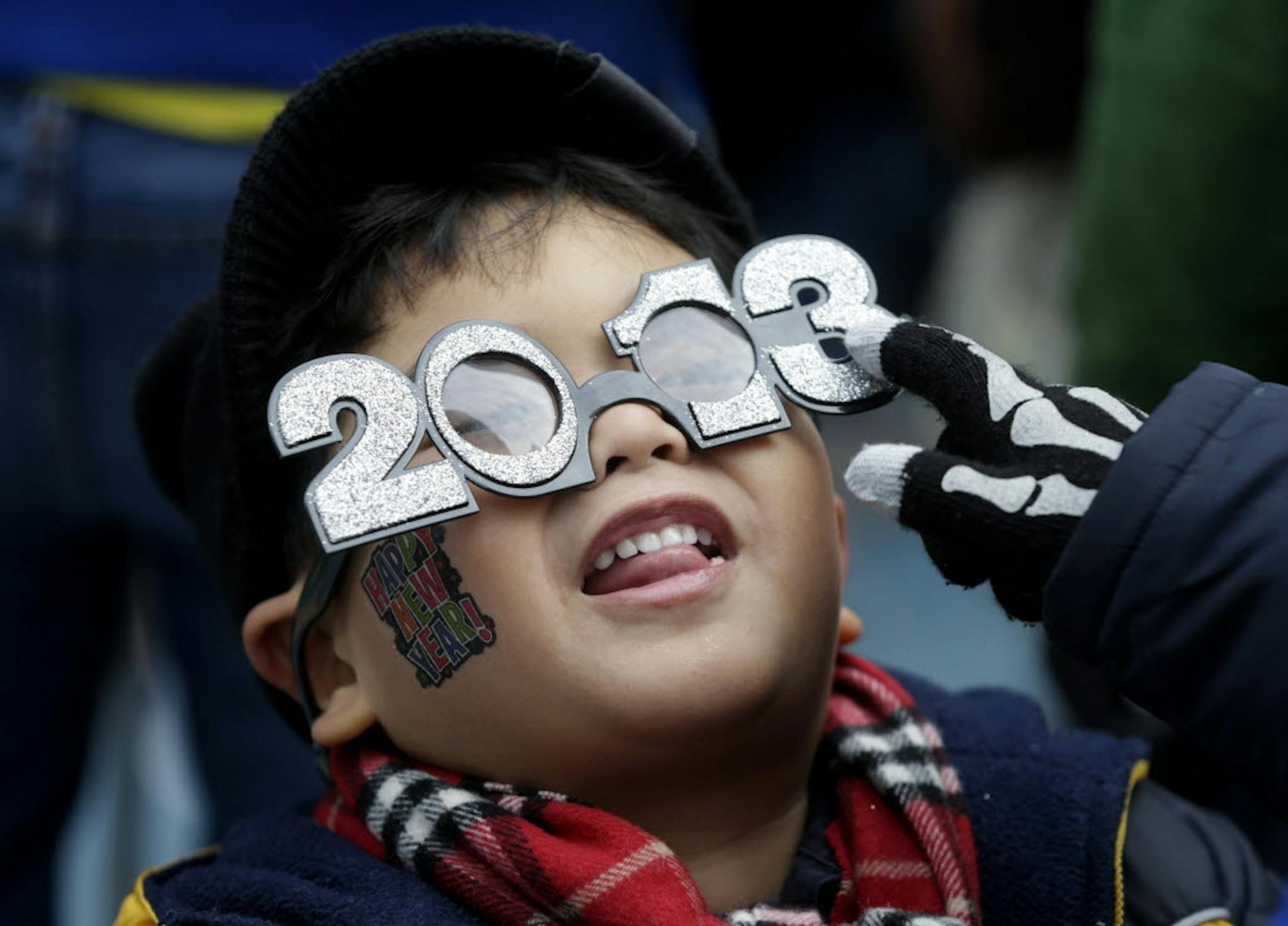 Benjamin Nadorf, 4, fools around with his new glasses while waiting for the New Year in Times Square in New York.