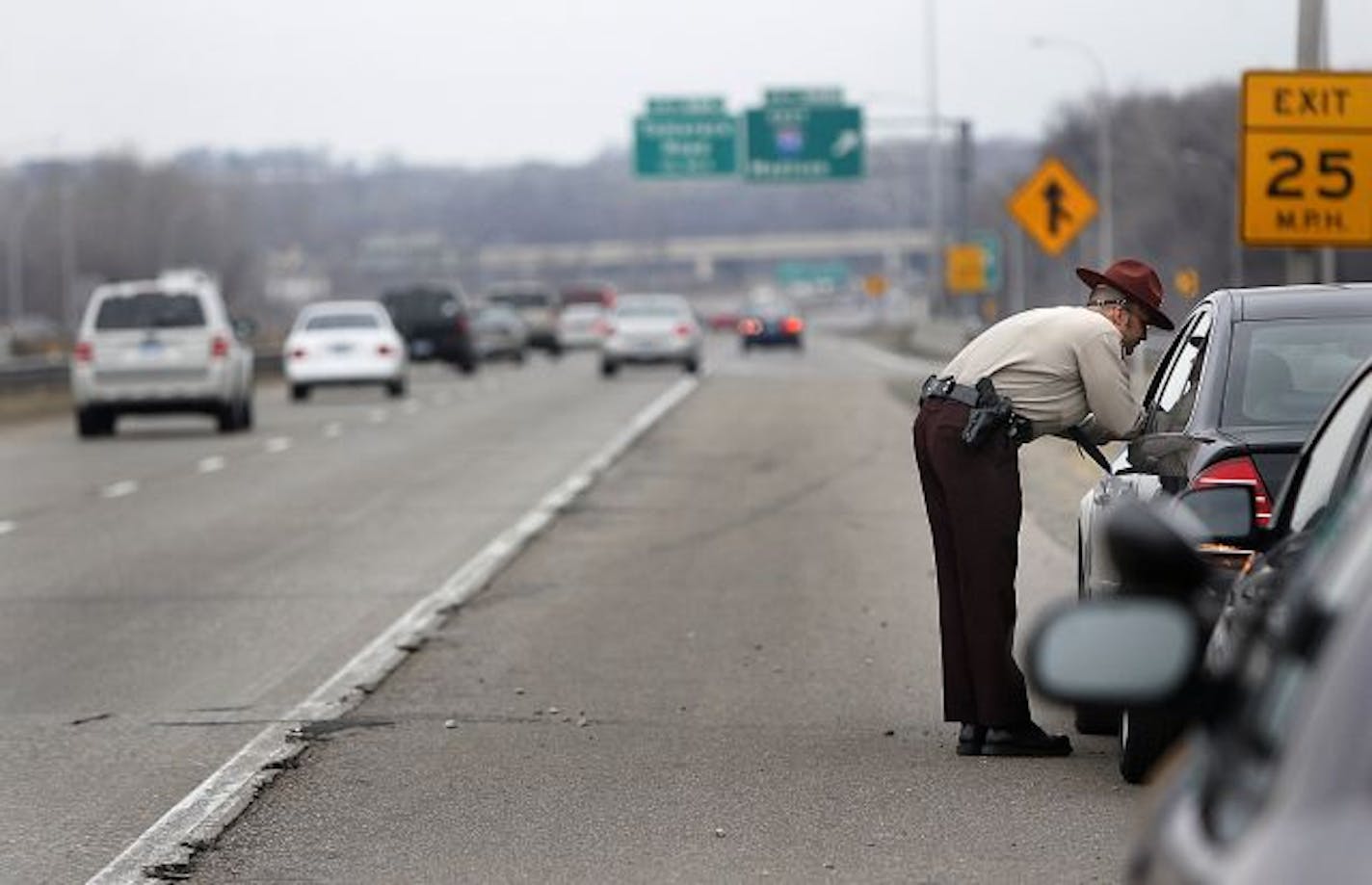 As drivers made their way along the Interstate behind him, Minnesota State Patrol, Sgt. Curt Thurmes spoke with a driver who had a small accident along Interstate 694 near Woodbury.