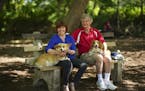 Kelly Bort with her partner, Richard Ekstrum, at the dog park at Lake of the Isles with their Corgis Little Girl, left, and Bennie. ] JEFF WHEELER •