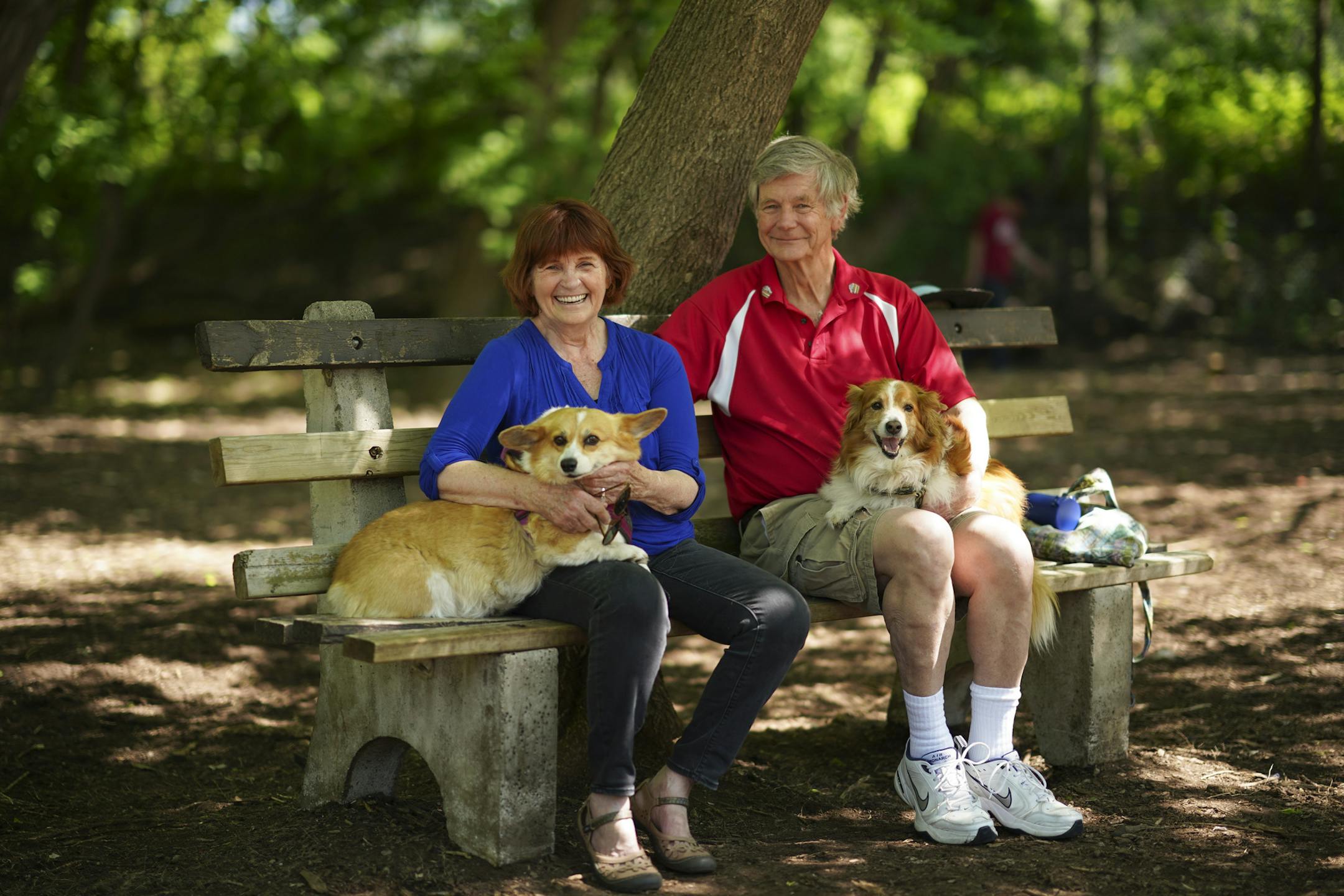 Kelly Bort with her partner, Richard Ekstrum, at the dog park at Lake of the Isles with their Corgis Little Girl, left, and Bennie. ] JEFF WHEELER • Jeff.Wheeler@startribune.com Kelly Bort spent five days in the hospital in March being treated for COVOD-19. Recovery has been slow, but Bort is now enjoying daily walks around Lake of the Isles with partner Richard Ekstrum, 75, and dogs Little Girl and Bennie (both Corgis). They were photographed at the dog park at Lake of the Isles Wednesday after
