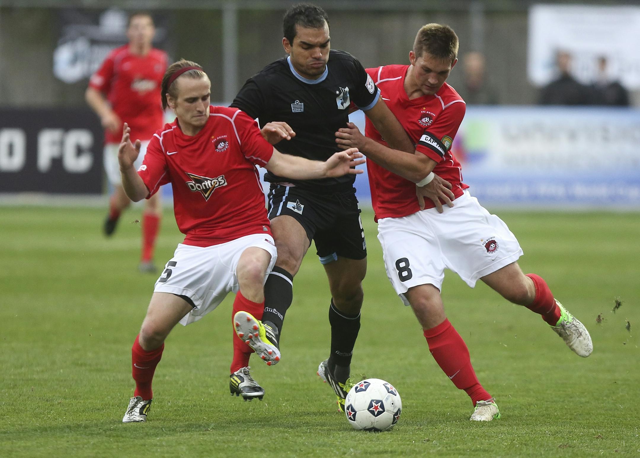 Minnesota United's Pablo Campos tried to get through the double team of Des Moines Menace's Brandon Fricke, right, and James Vollmer during the first half at Elizabeth Robie Stadium in St. Paul, Min., Tuesday, May 21, 2013