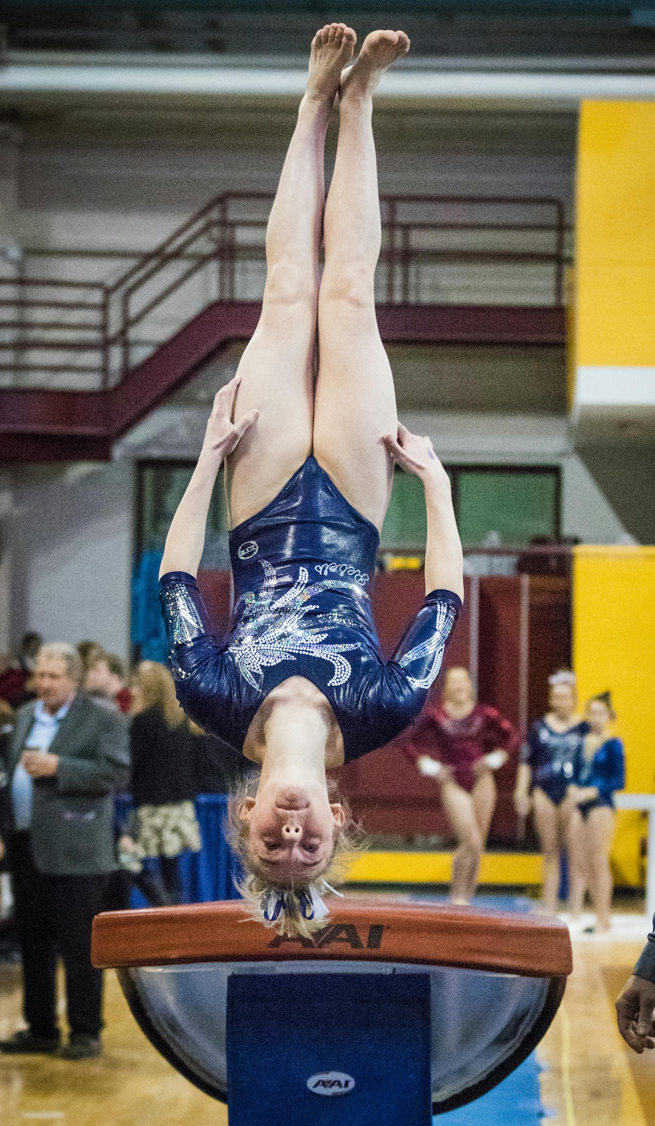 Champlin Park's Chaney Neu mid-flip after vaulting. Neu's vault placed her ahead of Edina's Megan Haug to win the Class 2A All-Around championship.
] MATT WEBER ï