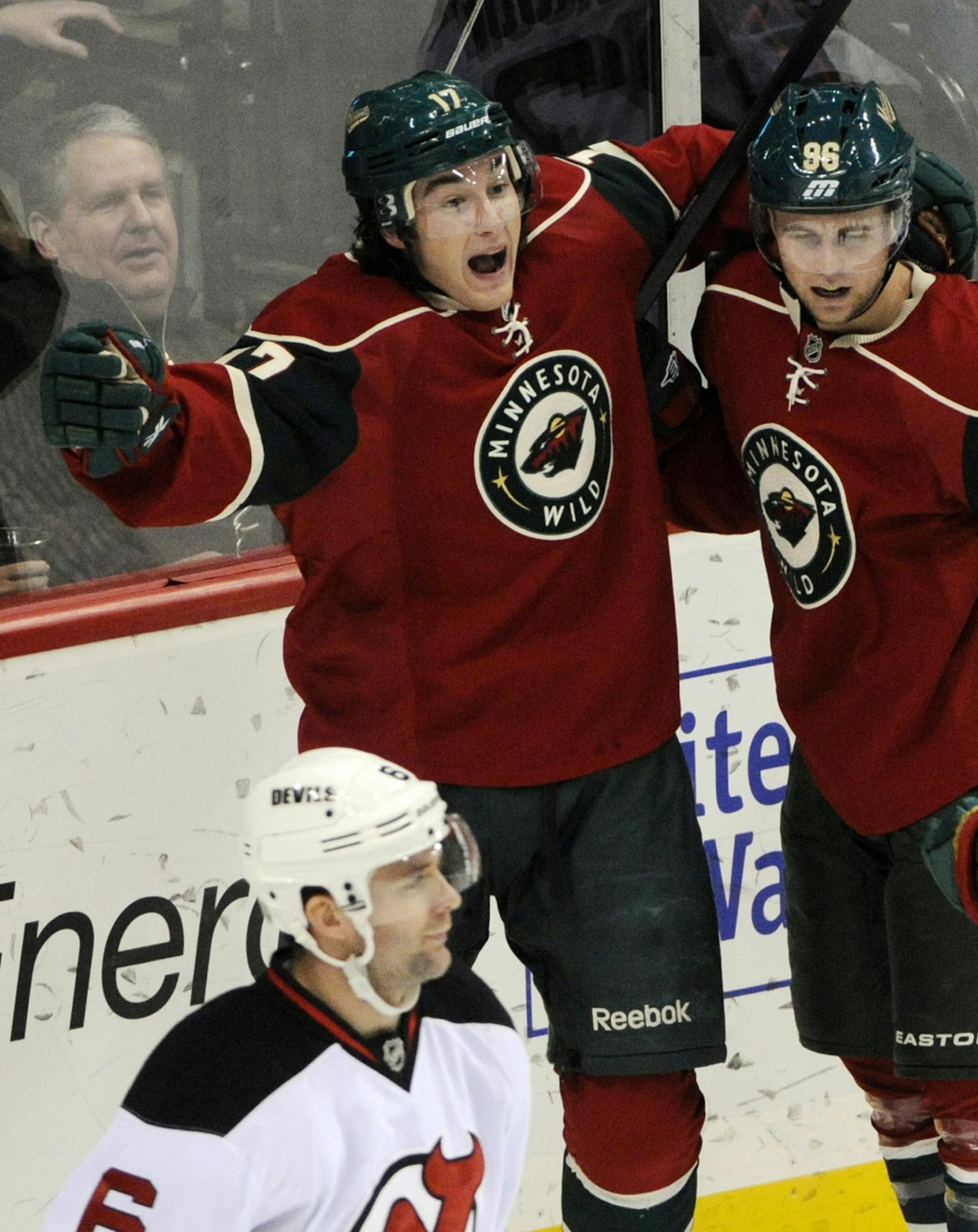 Minnesota Wild's Casey Wellman, left, and Pierre-Marc Bouchard celebrate Wellman's goal against New Jersey Devils goalie Martin Brodeur in the first period of an NHL hockey game, Friday, Dec. 2, 2011, in St. Paul, Minn.