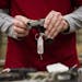FILE -- An employee displays a handgun at a gun store in Johnston, Iowa, Jan. 22, 2016. The decision to buy a handgun for the first time raises the pu