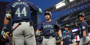 The Mariners' Cal Raleigh (29) celebrates with teammates after hitting a grand slam during the seventh inning against the Twins on Tuesday at Target F