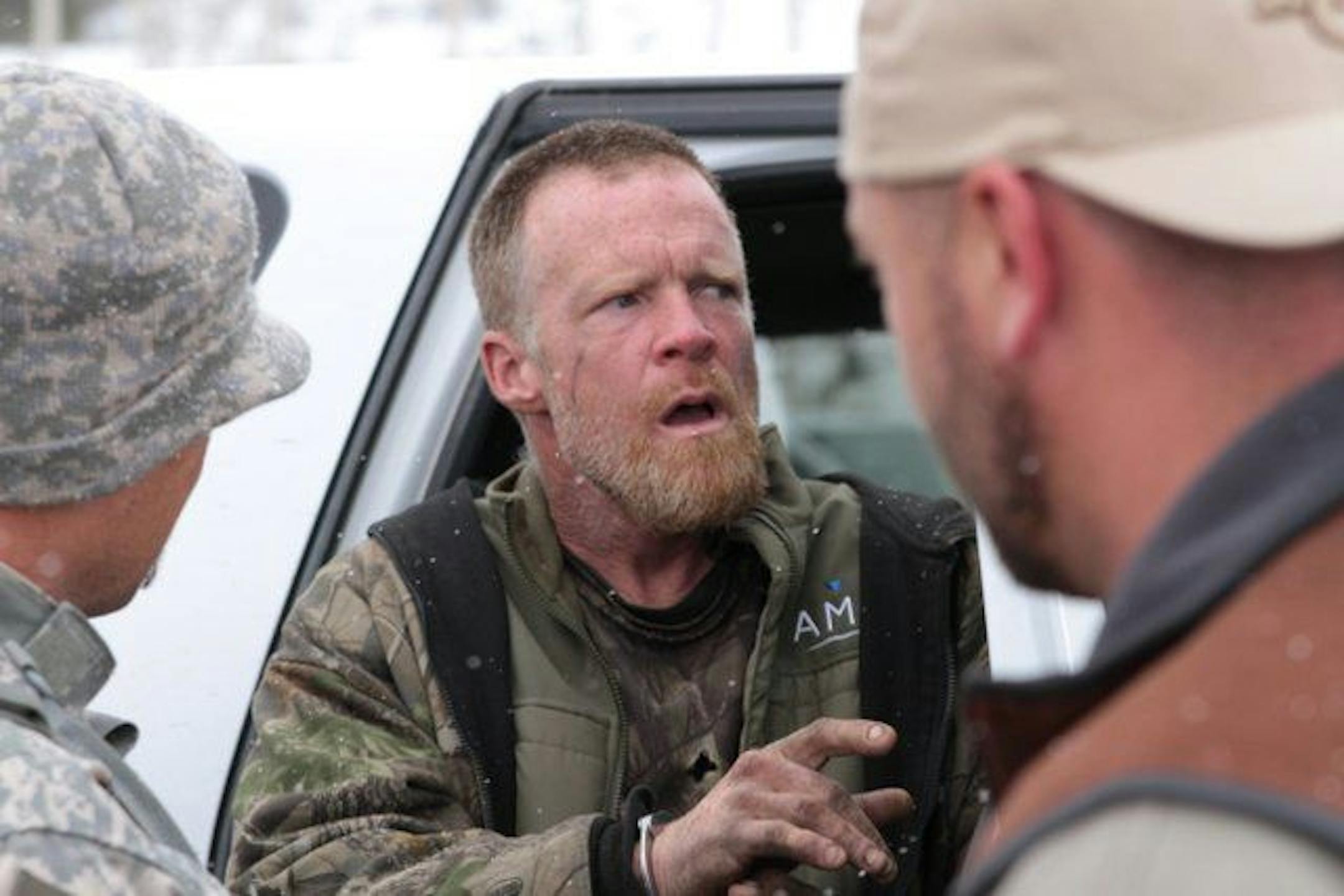 This image provided by the Emery County Sheriff's Office shows detectives placing fugitive Troy James Knapp into custody Tuesday April 2, 2013, in mountains outside of Ferron in central Utah. Authorities captured the elusive survivalist on Tuesday who is suspected of burglarizing Utah cabins and leaving some covered with threats and bullet holes � ending a saga that began six years ago.