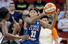 Minnesota Lynx's Seimone Augustus (33) looks for room to pass against the Seattle Storm during the second half of a WNBA basketball game Thursday, Jun