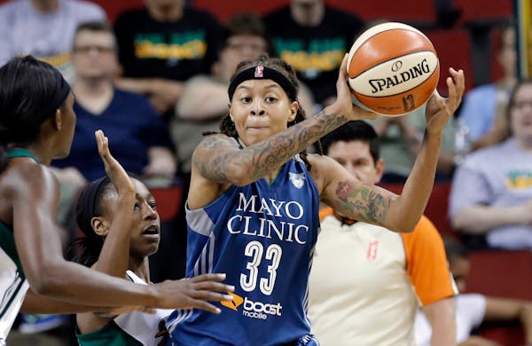 Minnesota Lynx's Seimone Augustus (33) looks for room to pass against the Seattle Storm during the second half of a WNBA basketball game Thursday, Jun