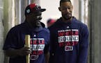 Minnesota Twins hitting coach James Rowson (82) joked with center fielder Byron Buxton (25) as they made their way to the batting cages Monday. ] ANTH