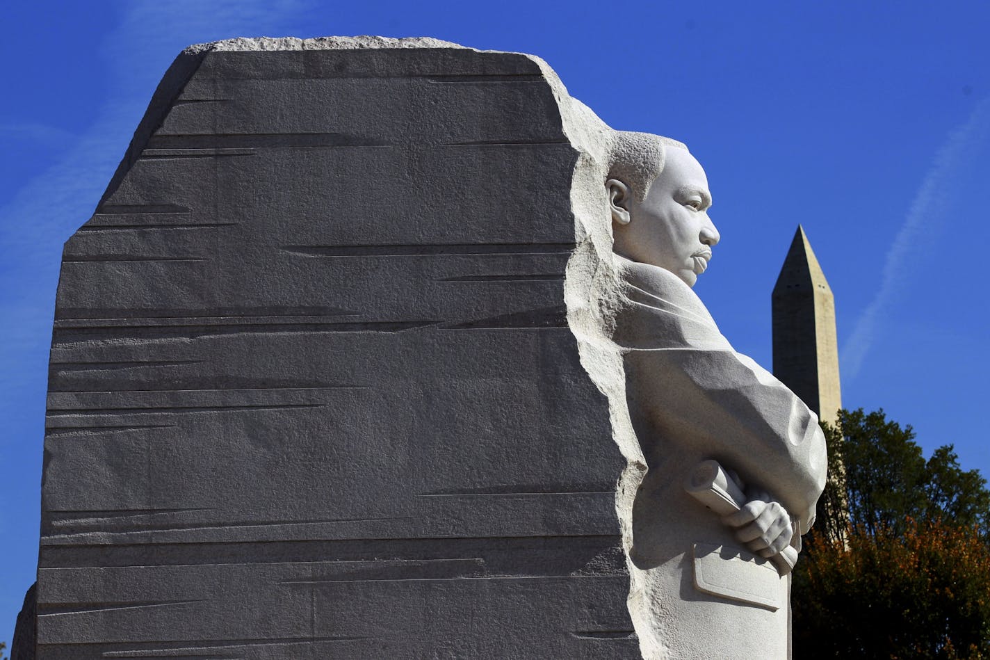 The monument at the Martin Luther King Jr. Memorial dedication, with the Washington Monument in the background, on the National Mall in Washington, Oct. 16, 2011. President Barack Obama called on Americans to use the memory of the Rev. Dr. Martin Luther King Jr. to help push for progress in today's economically tough times.