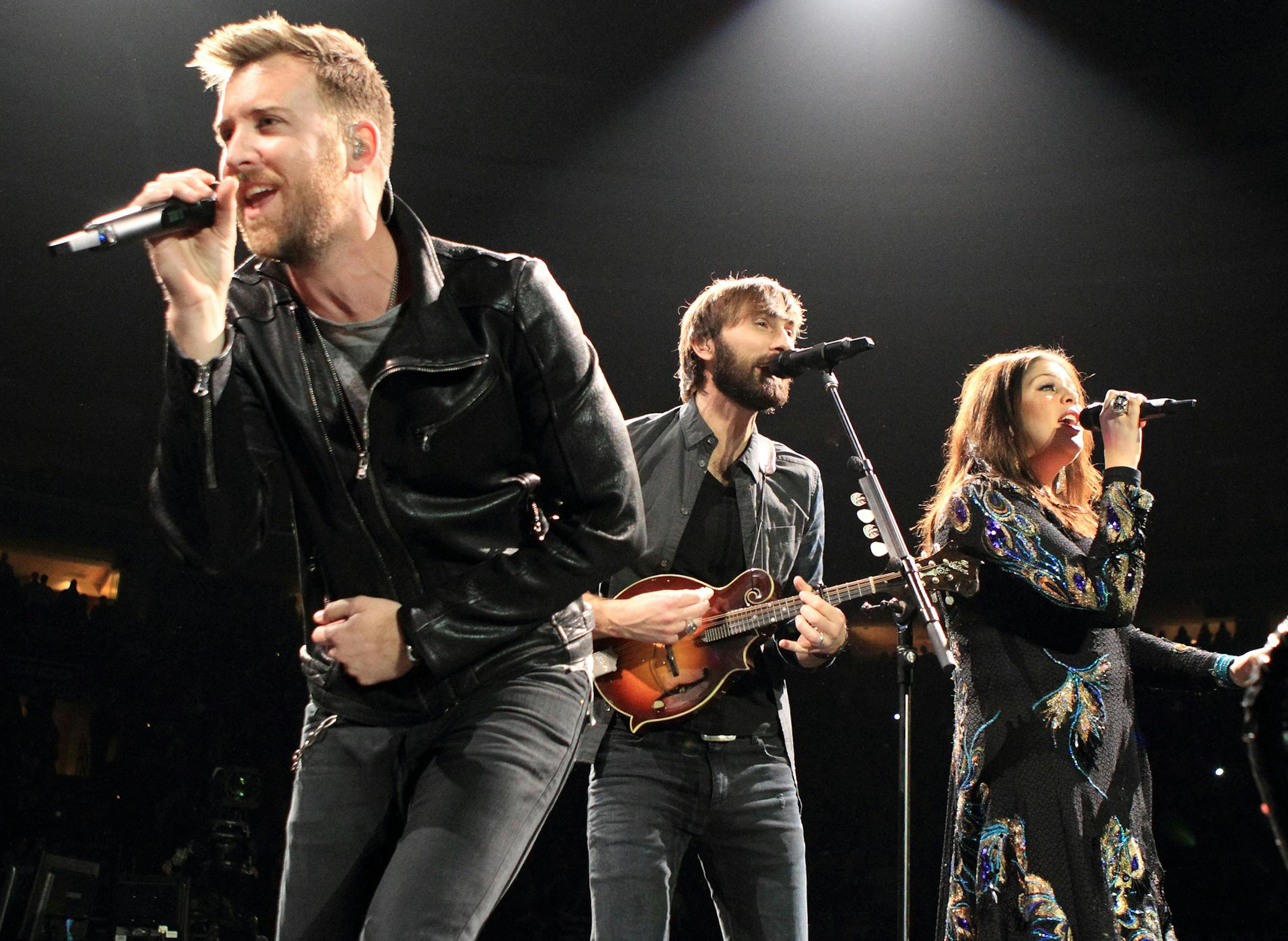 Charles Kelley, from left, Dave Haywood and Hillary Scott of the country pop music group Lady Antebellum perform in concert during their ìTake Me Downtown Tour 2014î at the Wells Fargo Center on Thursday, Jan. 30, 2014, in Philadelphia. (Photo by Owen Sweeney/Invision/AP)