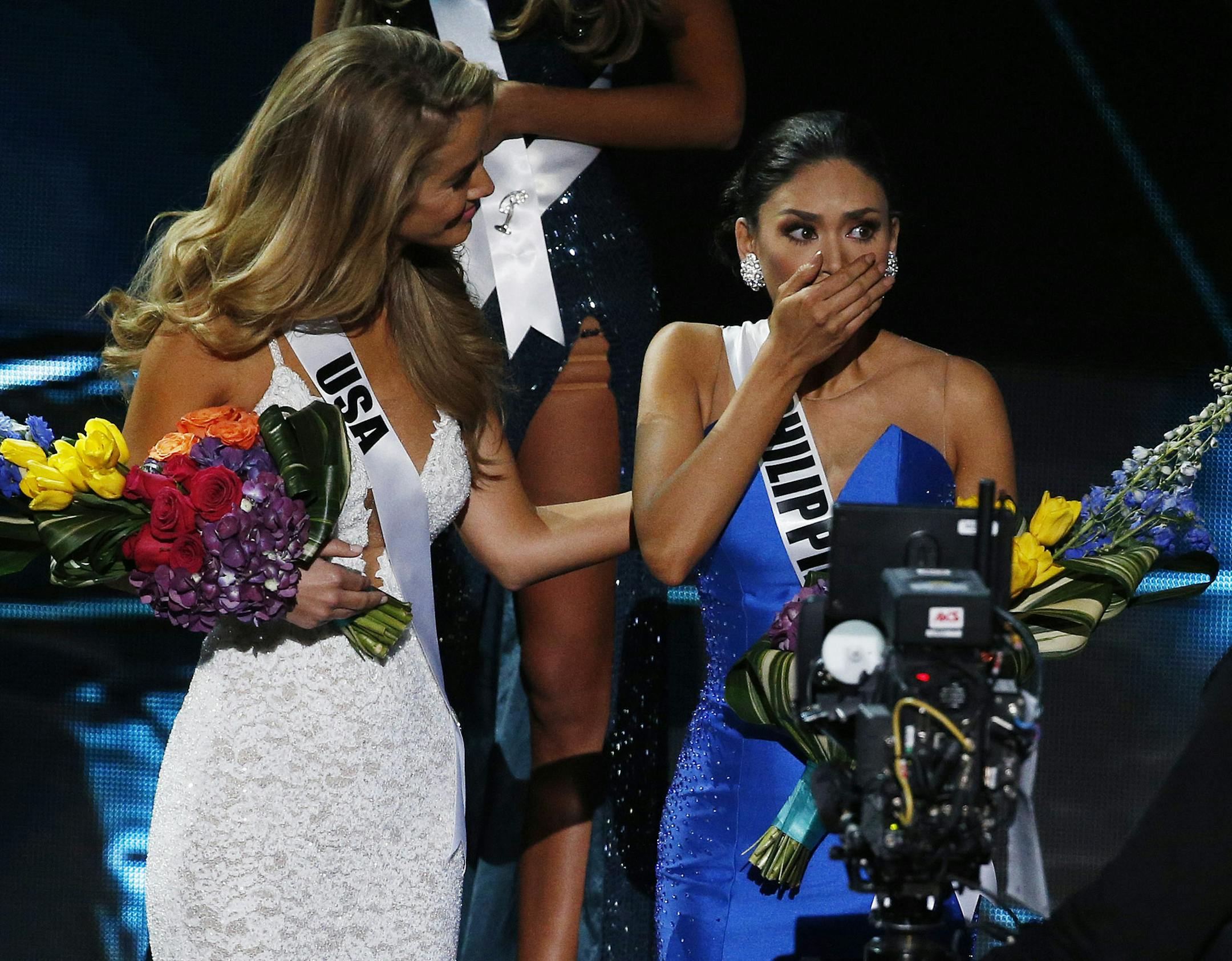 Miss Philippines Pia Alonzo Wurtzbach, right, reacts as she was announced as the new Miss Universe at the Miss Universe pageant on Sunday, Dec. 20, 2015, in Las Vegas. Miss Colombia Ariadna Gutierrez was incorrectly named as Miss Universe before her crown was taken away. (AP Photo/John Locher)