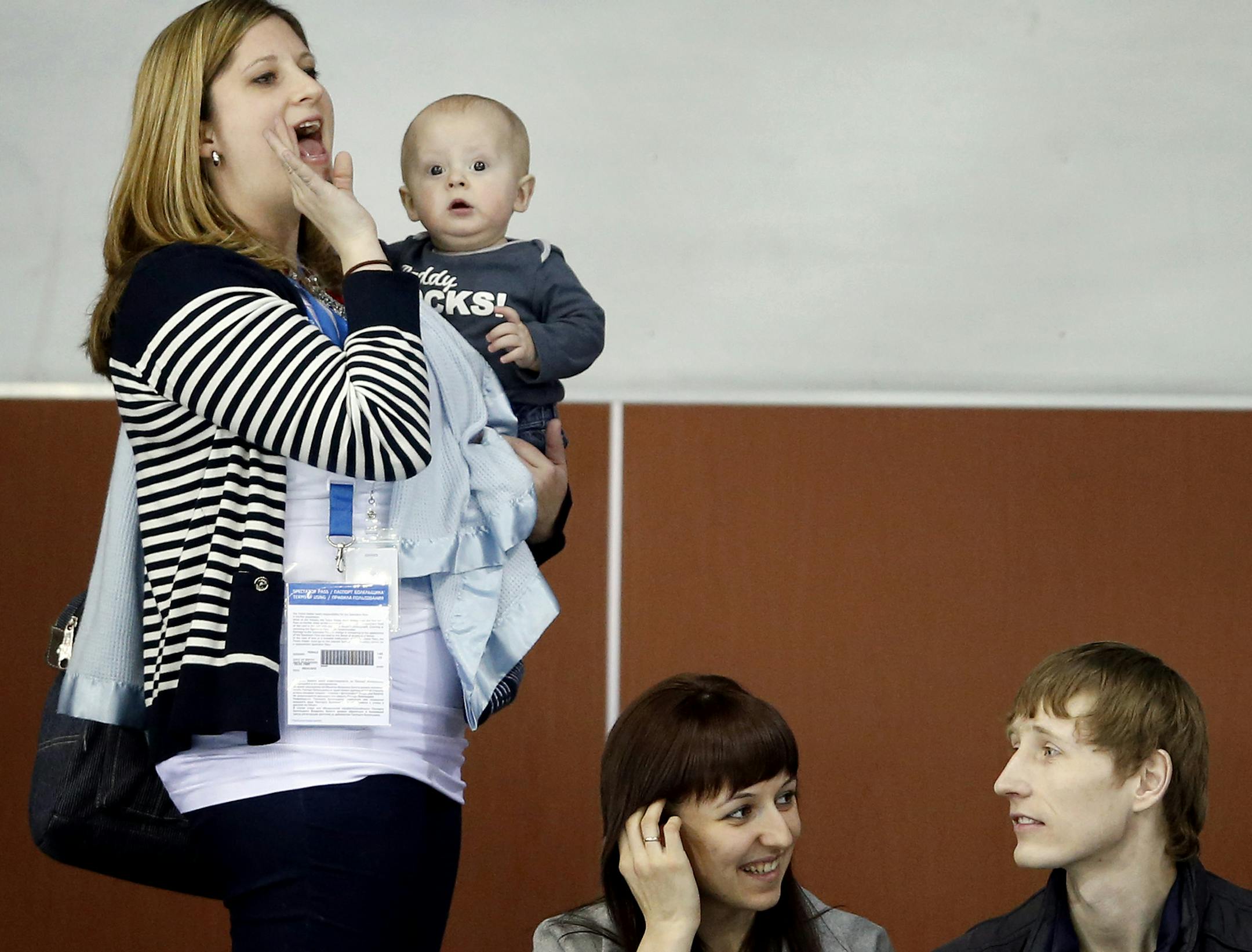 Sara Shuster holding son Luke called out to husband John Schuster during team introductions before Thursday's draw between USA and Great Britain in Men's Curling. ] CARLOS GONZALEZ cgonzalez@startribune.com - February 13, 2013, Sochi, Russia, Sochi 2014 Winter Olympics, Men‚Äö√Ñ√¥s Curling ORG XMIT: MIN1402130907501403