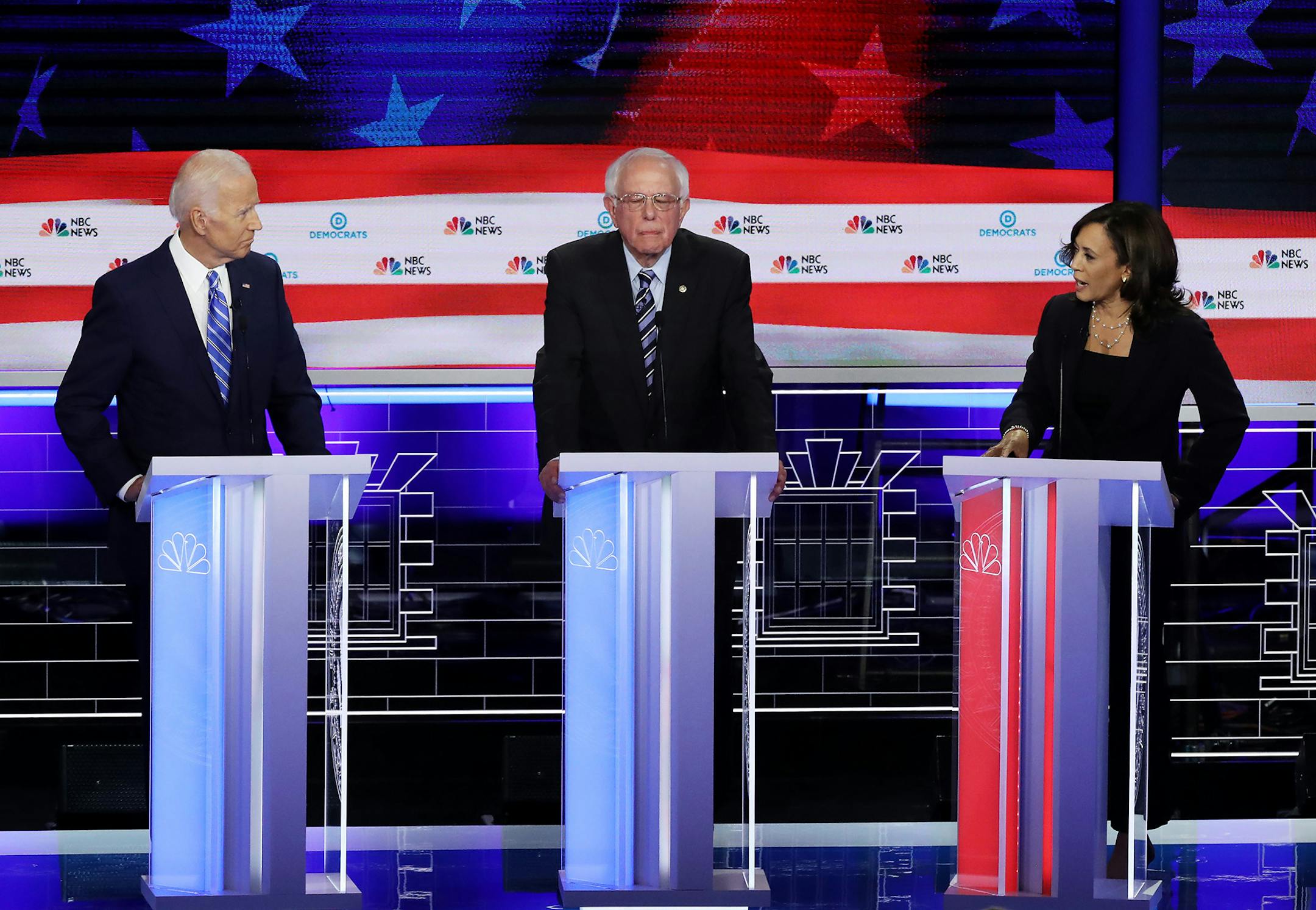 Sen. Kamala Harris (D-Calif.), right, speaks to former Vice President Joe Biden, left, as Sen. Bernie Sanders (I-Vt.) looks on during the second night of the first Democratic presidential debate on Thursday, June 27, 2019, at the Arsht Center for the Performing Arts in Miami. (Drew Angerer/Getty Images/TNS) **FOR USE WITH THIS STORY ONLY** ORG XMIT: 1348380
