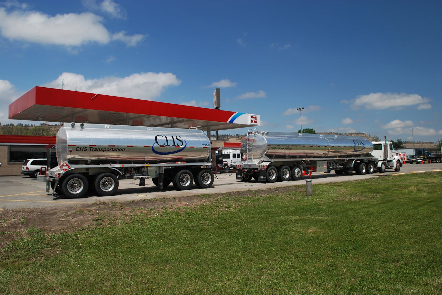 Fuel delivery CHS transportation tanker unloads fuel at a Cenex convenience store in Montana.