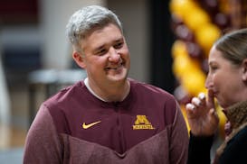 New University of Minnesota Volleyball head coach Keegan Cook chats with cross country head coach Sarah Hopkins after a press conference introducing h
