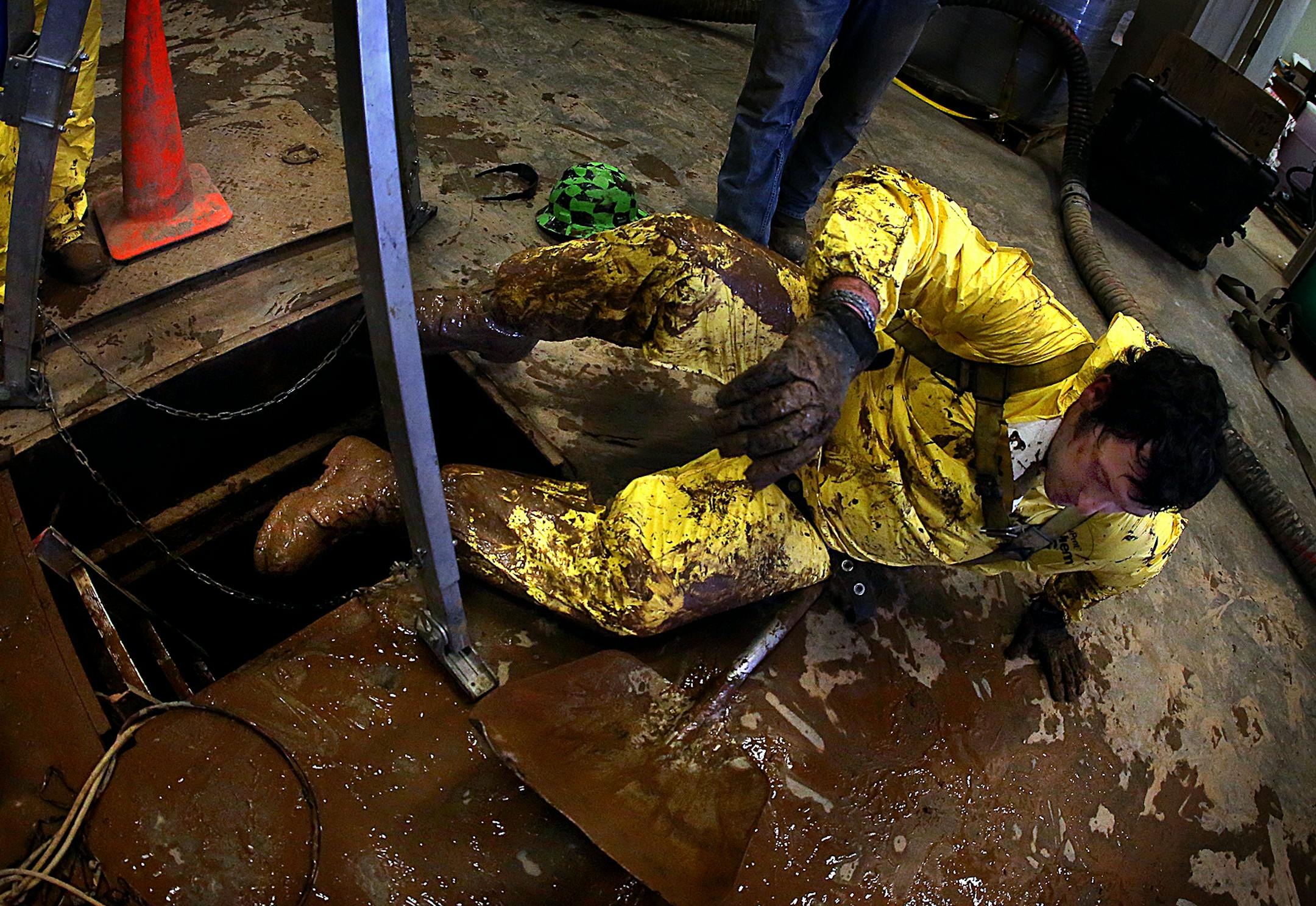 Caked with mud and sludge, Andrew Klefstad climbed out of the sludge pit after spending nearly an hour cleaning up. ] (JIM GEHRZ/STAR TRIBUNE) / September 26, 2013, Dickinson, ND ñ BACKGROUND INFORMATION- PHOTOS FOR USE IN FIRST PART OF NORTH DAKOTA OIL BOOM PROJECT: Andrew Klefstad, 28, is the general manager of an environmental company that cleans up frac gel-spills and scrubs sludge off trucks that serve the needs of the oil boom in the Bakken oil fields of North Dakota. Klefstad, works