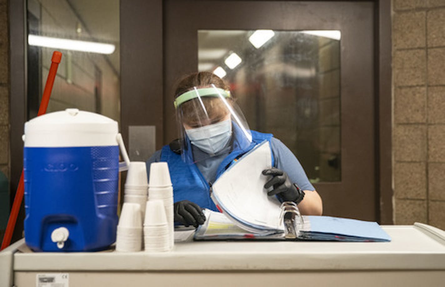 Health technician Kelsey Reeves flipped through her log of inmates while distributing medication to them on Tuesday at St. Louis County jail. ]
ALEX KORMANN &#x2022; alex.kormann@startribune.com The St. Louis County jail population has fallen dramatically as fewer arrests are made, which has helped keep a COVID-19 outbreak at bay inside the prison.