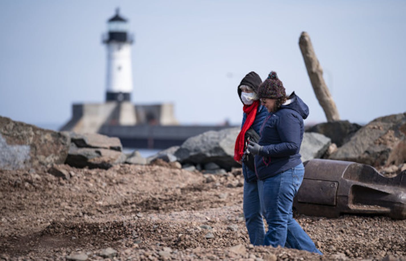 Two women walked through Canal Park, with one wearing a protective face mask, on Monday afternoon. ]
ALEX KORMANN &#x2022; alex.kormann@startribune.com Duluth residents tried to find ways to get out of their homes while still social distancing on Monday March 23, 2020.