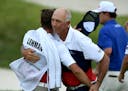 Tom Lehman hugged his caddie after shoot a 4-under 67 in the first round of the 3M Open at TPC Twin Cities in Blaine. ] AARON LAVINSKY• aaron.lavins