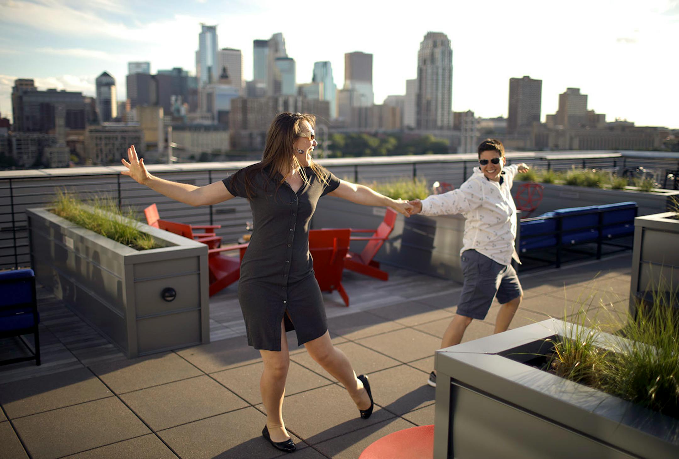 After drinks on the rooftop with friends who live in the A-Mill Lofts, Maryrose Dolezal and Roya Moltaji, right, danced with each other when "their" song ("Moondance" by Van Morrison) came on. They were celebrating the fourth anniversary of the day they met.