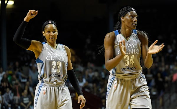 Minnesota Lynx forward Maya Moore (23) and Minnesota Lynx center Sylvia Fowles (34) celebrated after forcing a Mystics timeout in the third quarter Tu