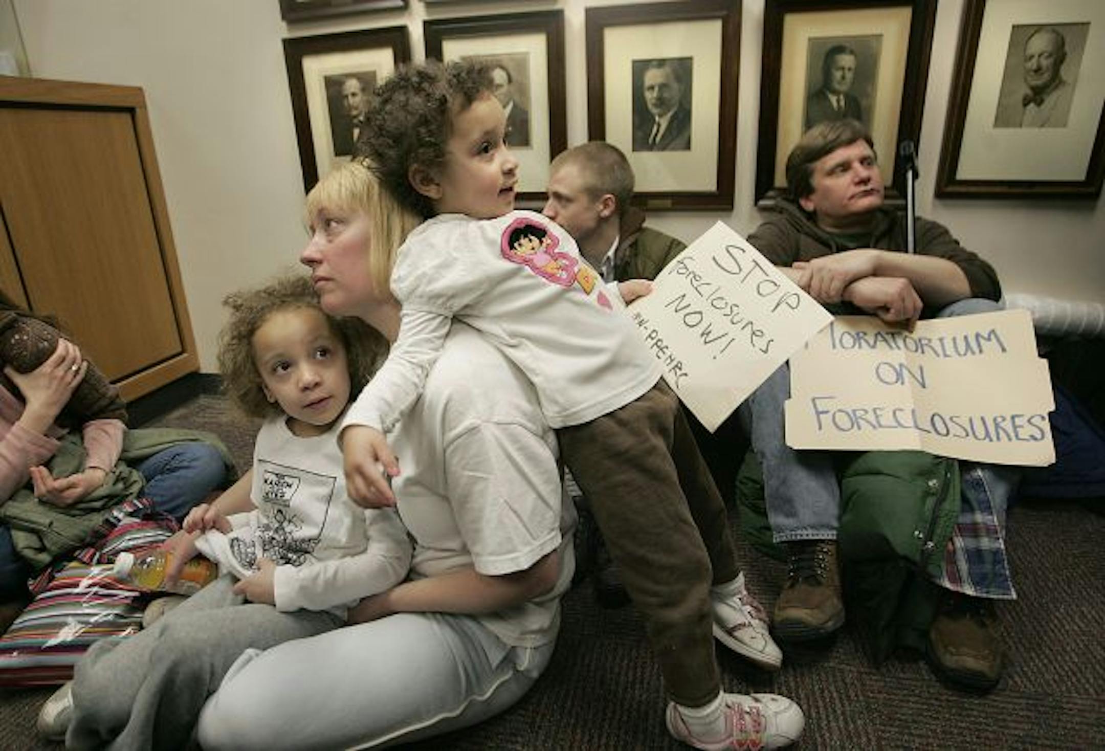"If I lose my job, I'll lose my house," said Ann Patterson as she participated in a sit-in Wednesday at the Hennepin County Sheriff's Office in Minneapolis. Patterson brought along her daughters Ruby, 5, left, and Shani, 3, as she joined others in an attempt to stop a sheriff's sale at 10 a.m.