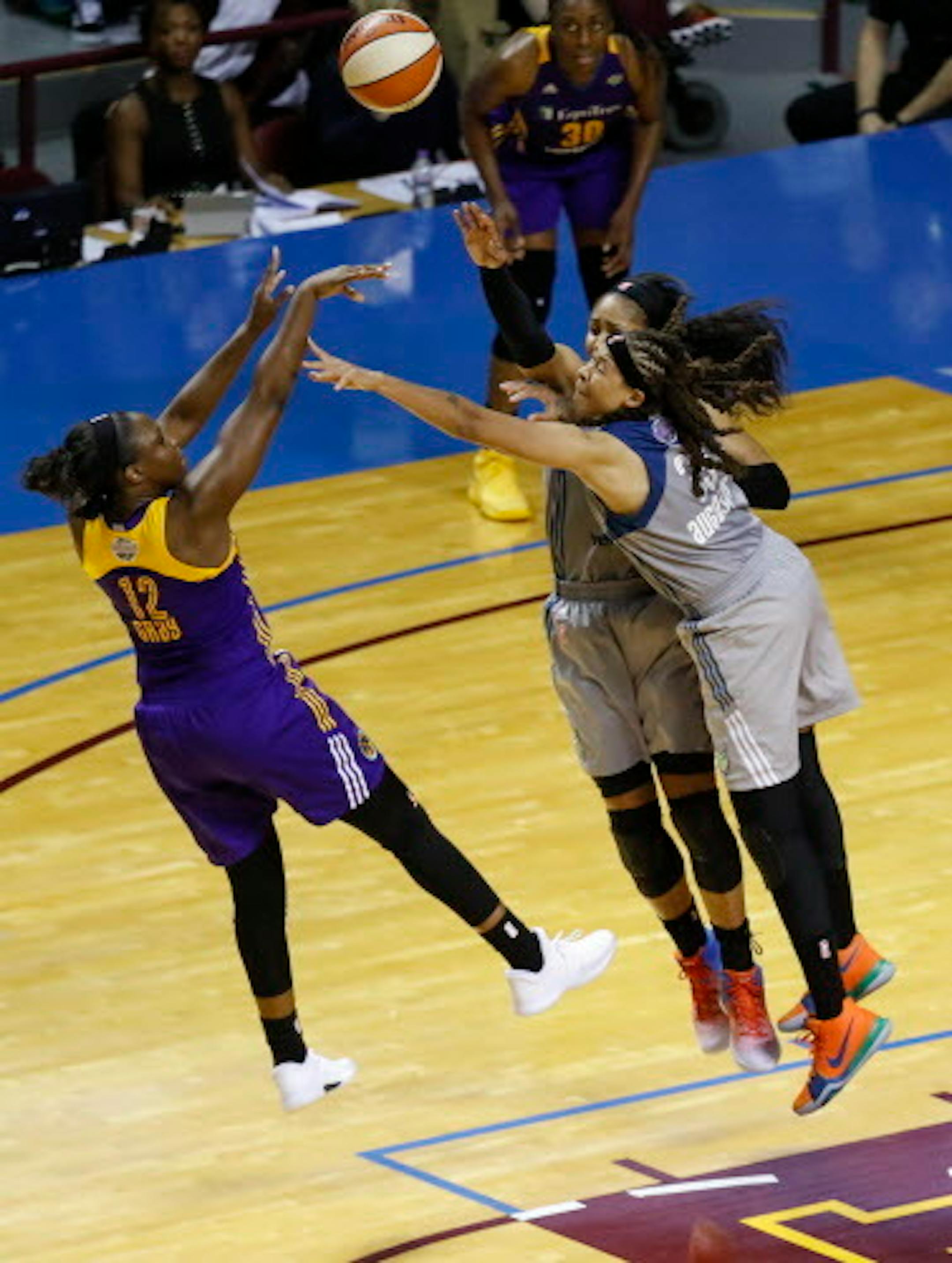 Los Angeles Sparks guard Chelsea Gray (12) shoots the game-winning shot as Minnesota Lynx forward Maya Moore (23) and guard Seimone Augustus (33) apply pressure late in the second half in Game 1 of the WNBA finals on Sunday, Sept. 24, 2017, at Williams Arena in Minneapolis. The Sparks won, 85-84. (Renee Jones Schneider/Minneapolis Star Tribune/TNS)