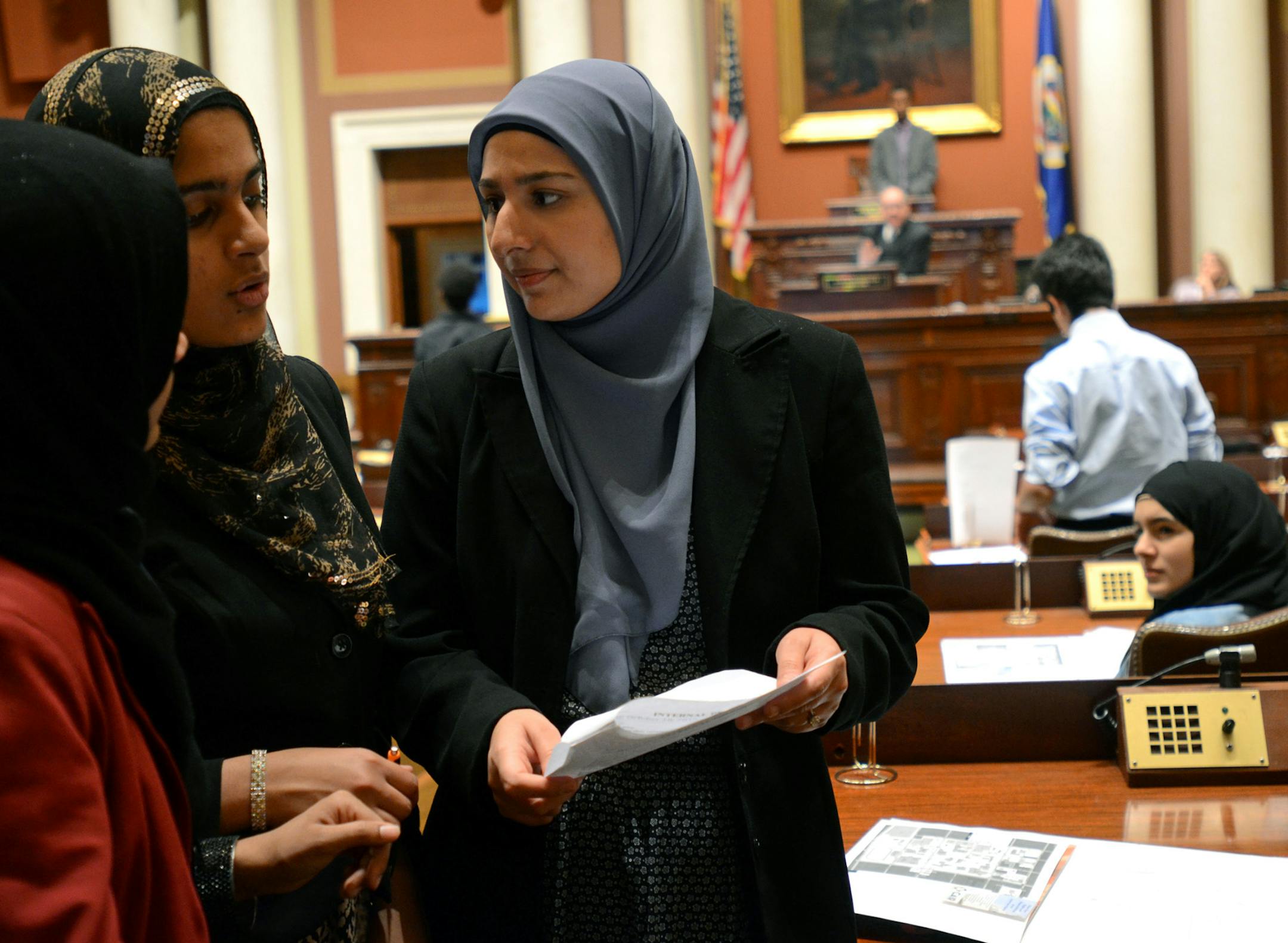 (At center) Lori Saroya, executive director of the Minnesota Chapter of the Council on American-Islamic Relations, talked with(left to right) Maher Mahmood and Suheila Musani, both with the Muslim Youth Leadership Symposium (MYLS). They were at the MYLS Jewish-Muslim Student Mock Legislature at the State Capitol. ] Joey McLeister,Special to the Star Tribune,St.Paul,MN October16,2013