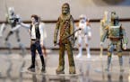 FILE- In this Feb. 18, 2014, file photo, Star Wars figurines are displayed at the Hasbro showroom during the American International Toy Fair in New Yo