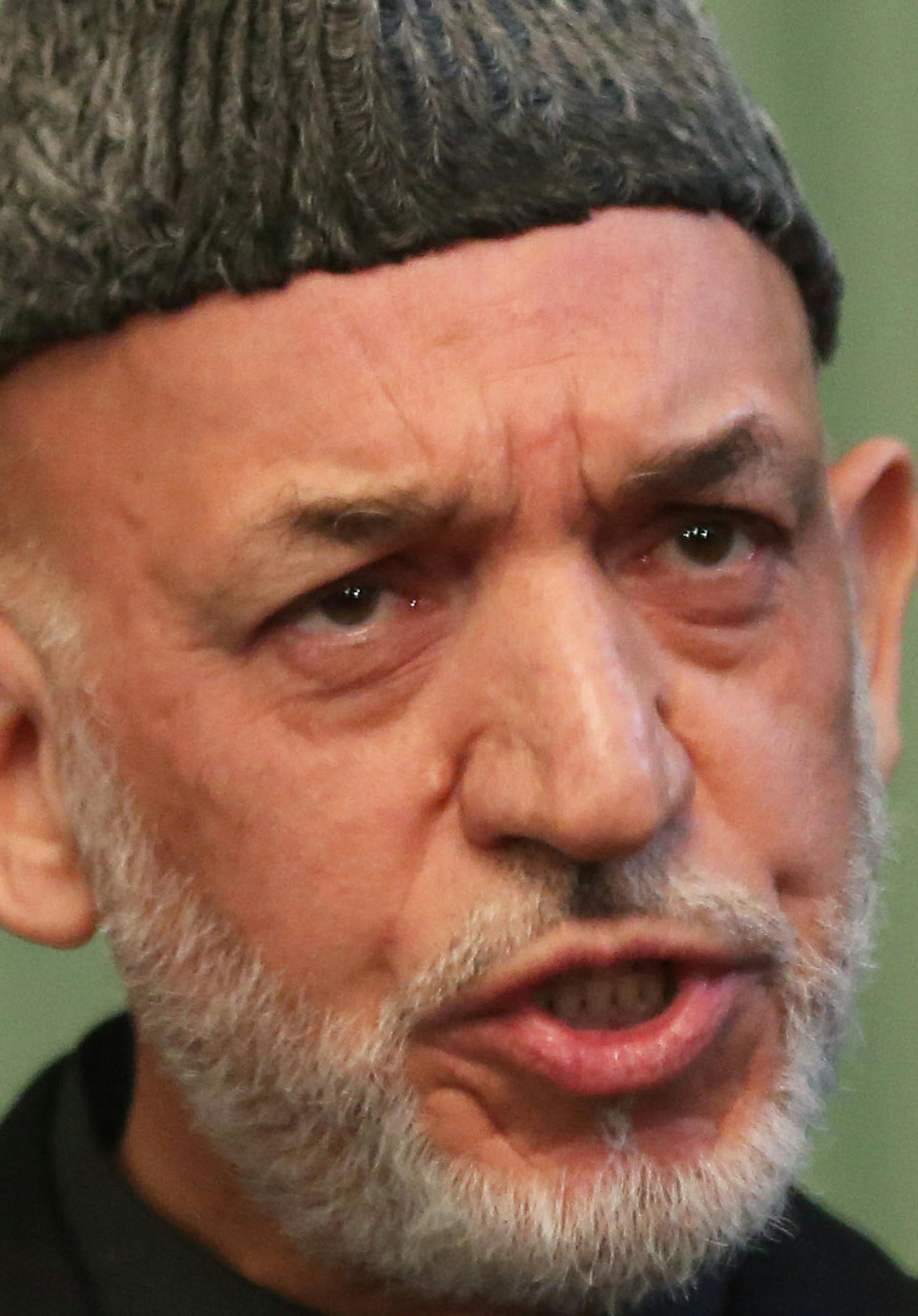 Afghan President Hamid Karzai speaks during a press conference at the presidential palace in Kabul, Afghanistan, Saturday, Jan. 25, 2014. Karzai said he will not sign a security pact with the United States unless Washington and Pakistan launch a peace process with Taliban insurgents. (AP Photo/Massoud Hossaini)