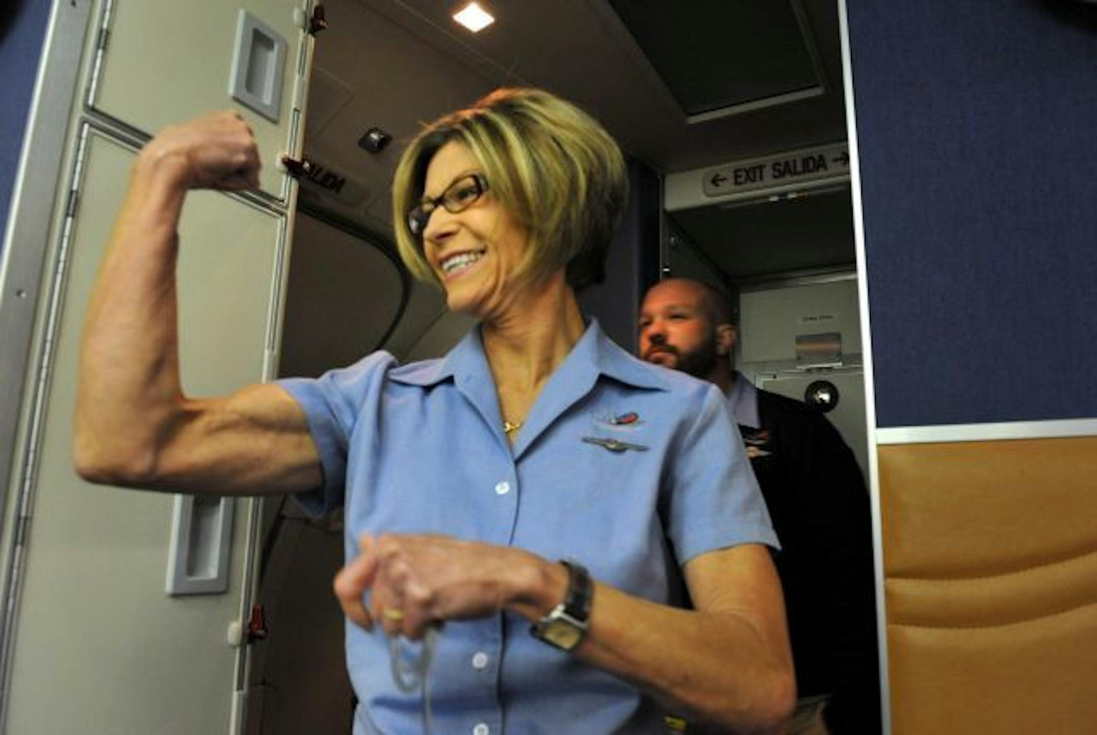 Southwest Airlines flight attendant Venita Morehead flexed her muscle as Michael Applegate told passengers that Venita would strictly enforce the no-smoking and seat-belt policy on the first flight from the Twin Cities.
