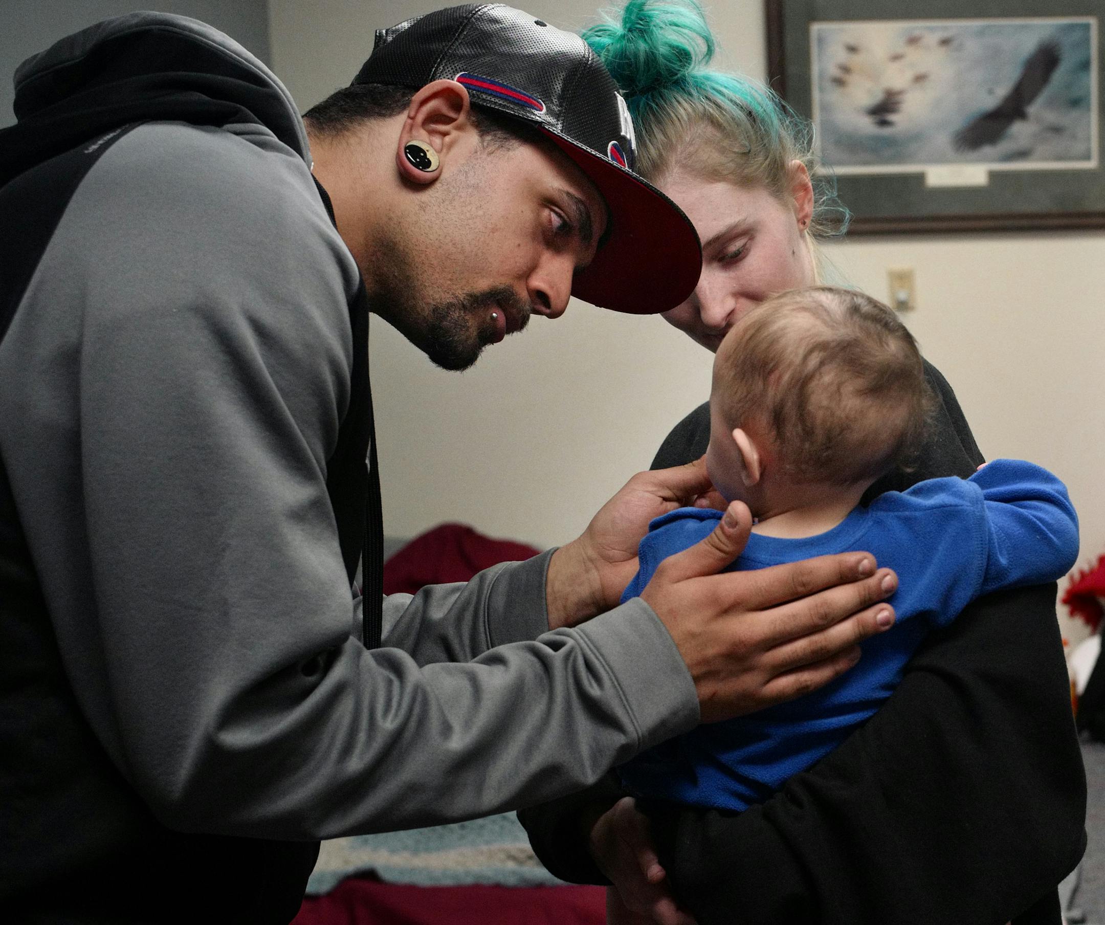 Stephen Davis and his partner, Ashley Brennan administer some baby Tylenol to eighth month old son, Cody after suffering from teething issues. Ashley works and goes to school full time while Stephen takes care of the child during the day.]Spurred on by frigid temperatures and dozens of needy people, several south metro churches are hosting a traveling shelter for Dakota County's homeless population. Dakota County officials sent out a call for help mid-month and Prince of Peace Lutheran is the cu