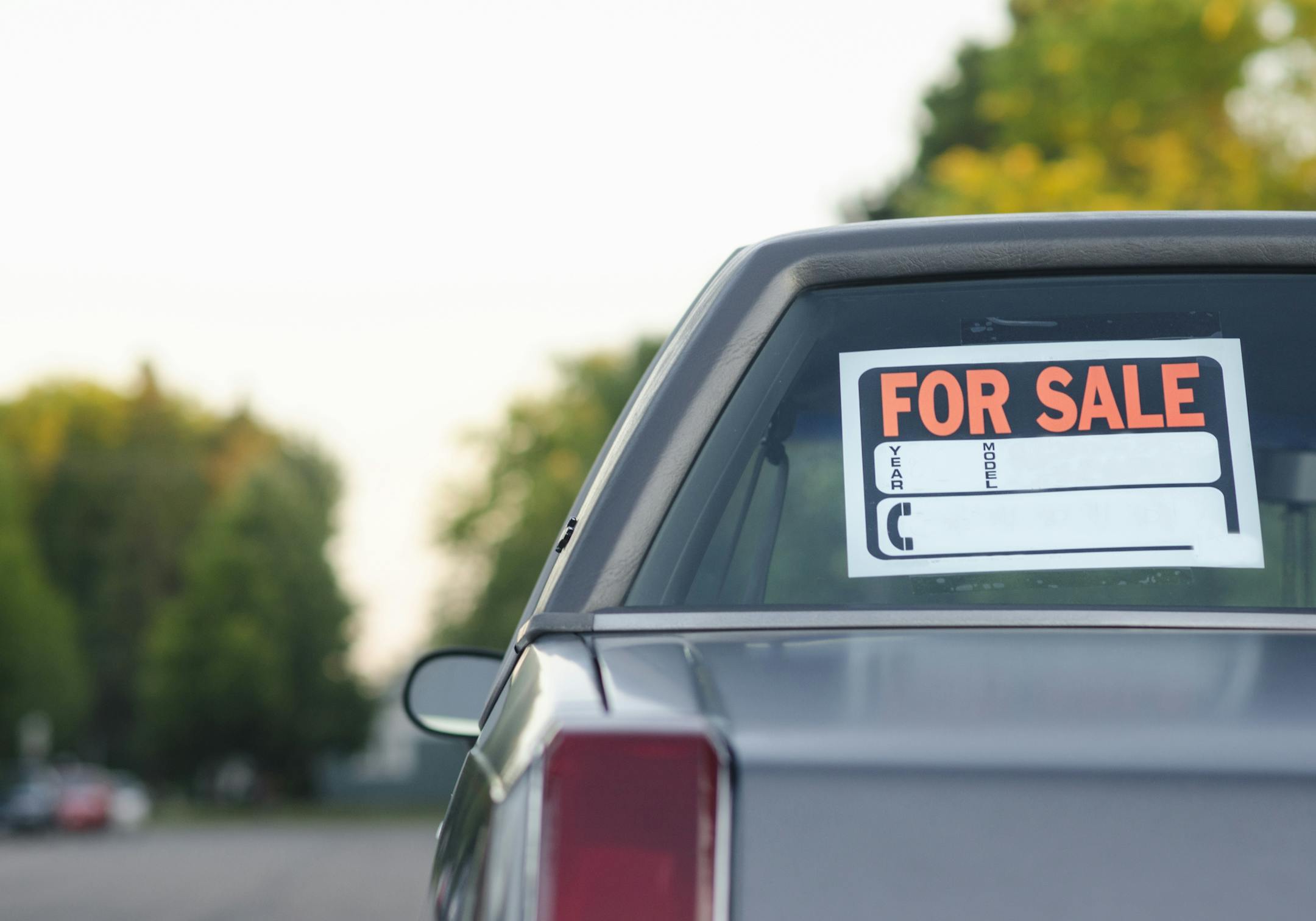 Parked vehicle for sale on a street. istock