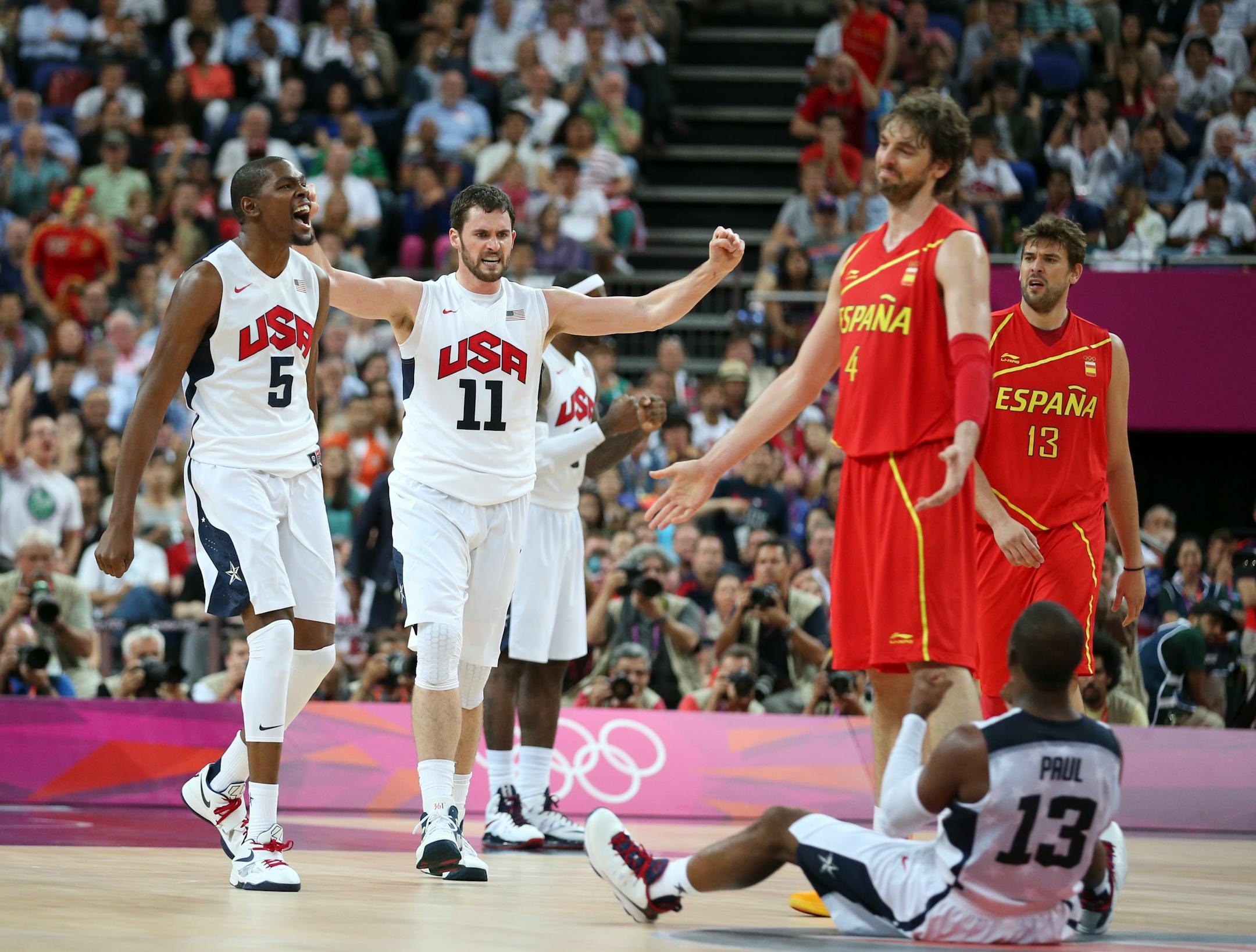 U.S. players Kevin Love (11), Chris Paul (13) and Kevin Durant (5) and Spain's Pau Gasol (4) during the men's basketball final between the U.S. and Spain at the 2012 Summer Olympic Games in London, Aug. 12, 2012. The U.S. won the game with a final score of 107-100. (Doug Mills/The New York Times)
