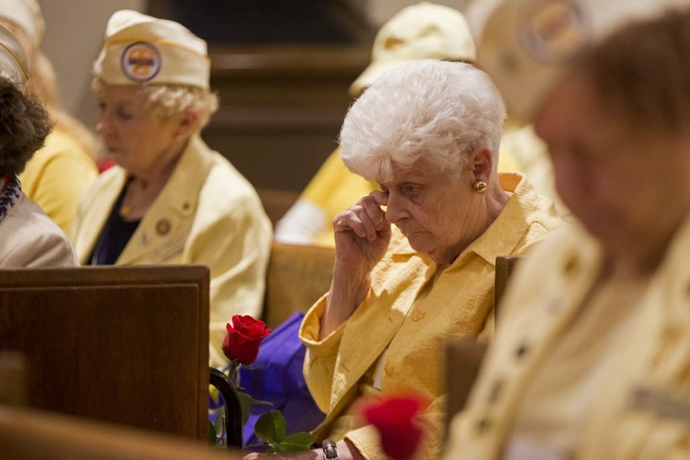 Terese Dugger wipes a tear from her eye during the prayer at the memorial service.