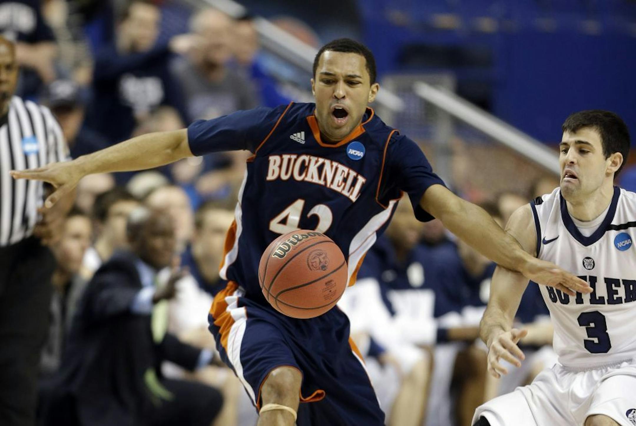 Bucknell guard Cameron Ayers (42) has the ball knocked away by Butler guard Alex Barlow (3) during the first half their second round NCAA college basketball tournament game Thursday, March 21, 2013, in Lexington, Ky.