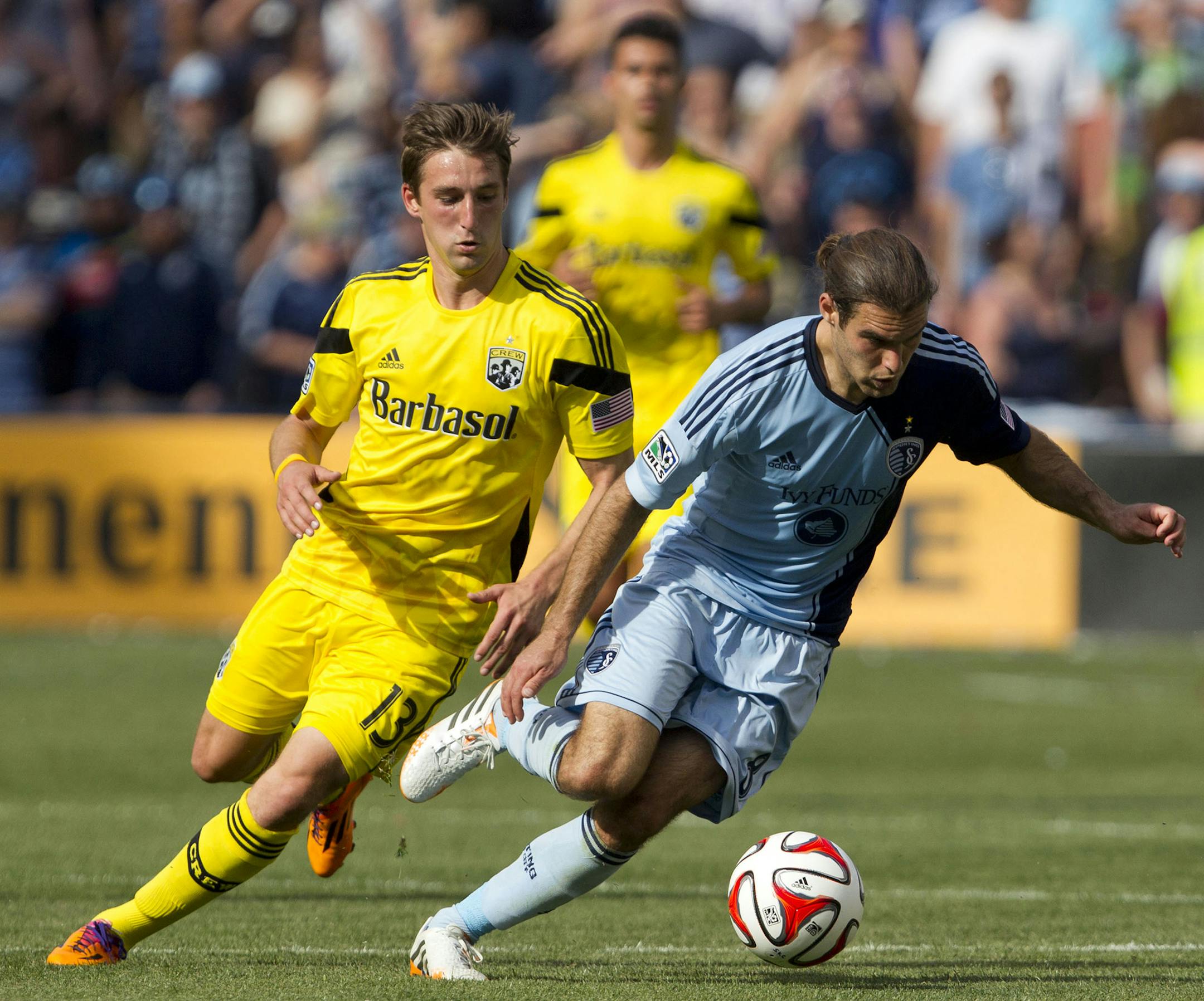 Columbus Crew midfielder Ethan Finlay (13) watches as Sporting Kansas City midfielder Graham Zusi (8) runs away with the ball in the second half during the Major League Soccer match at Sporting Park on Sunday, May 4, 2014 in Kansas City, Kan. Sporting Kansas City beat Columbus 2-0. (AP Photo/The Kansas City Star,Shane Keyser ) ORG XMIT: MIN2014060614514764