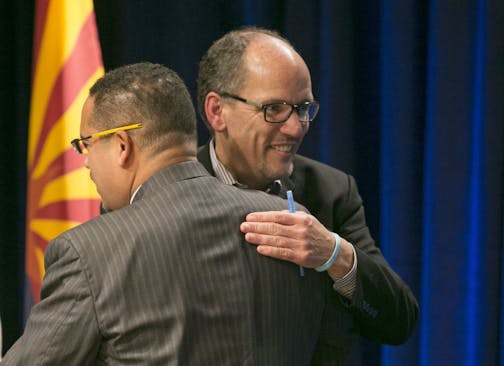 U.S. Secretary of Labor Tom Perez, right, a candidate for the Democratic National Committee chair hugs U.S. Representative Keith Ellison, MN-5, also a candidate also for the DNC chair, during the DNC Future of the Party Forum at the Sheraton Grand Phoenix Hotel, Saturday, Jan. 14, 2017, in Phoenix.