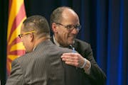 U.S. Secretary of Labor Tom Perez, right, a candidate for the Democratic National Committee chair hugs U.S. Representative Keith Ellison, MN-5, also a
