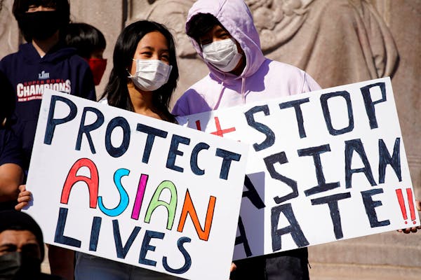 FILE - This March 20, 2021, file photo shows people holding signs as they attend a rally to support Stop Asian Hate at the Logan Square Monument in Ch