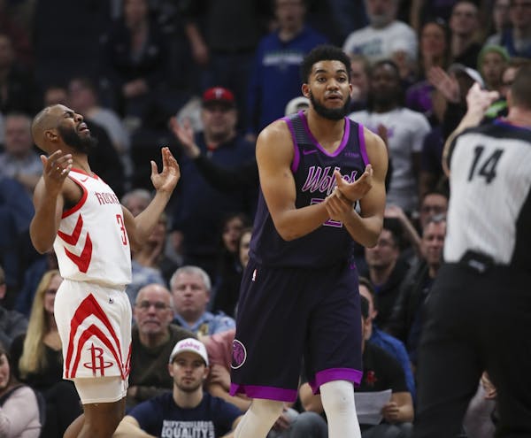 Minnesota Timberwolves center Karl-Anthony Towns (32) appealed to official Ed Malloy that a ball that went out of bounds was last touched by Houston R