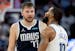 Mavericks guard Luka Doncic talks with Wolves guard Mike Conley in the fourth quarter of Game 1 of the Western Conference finals at Target Center.