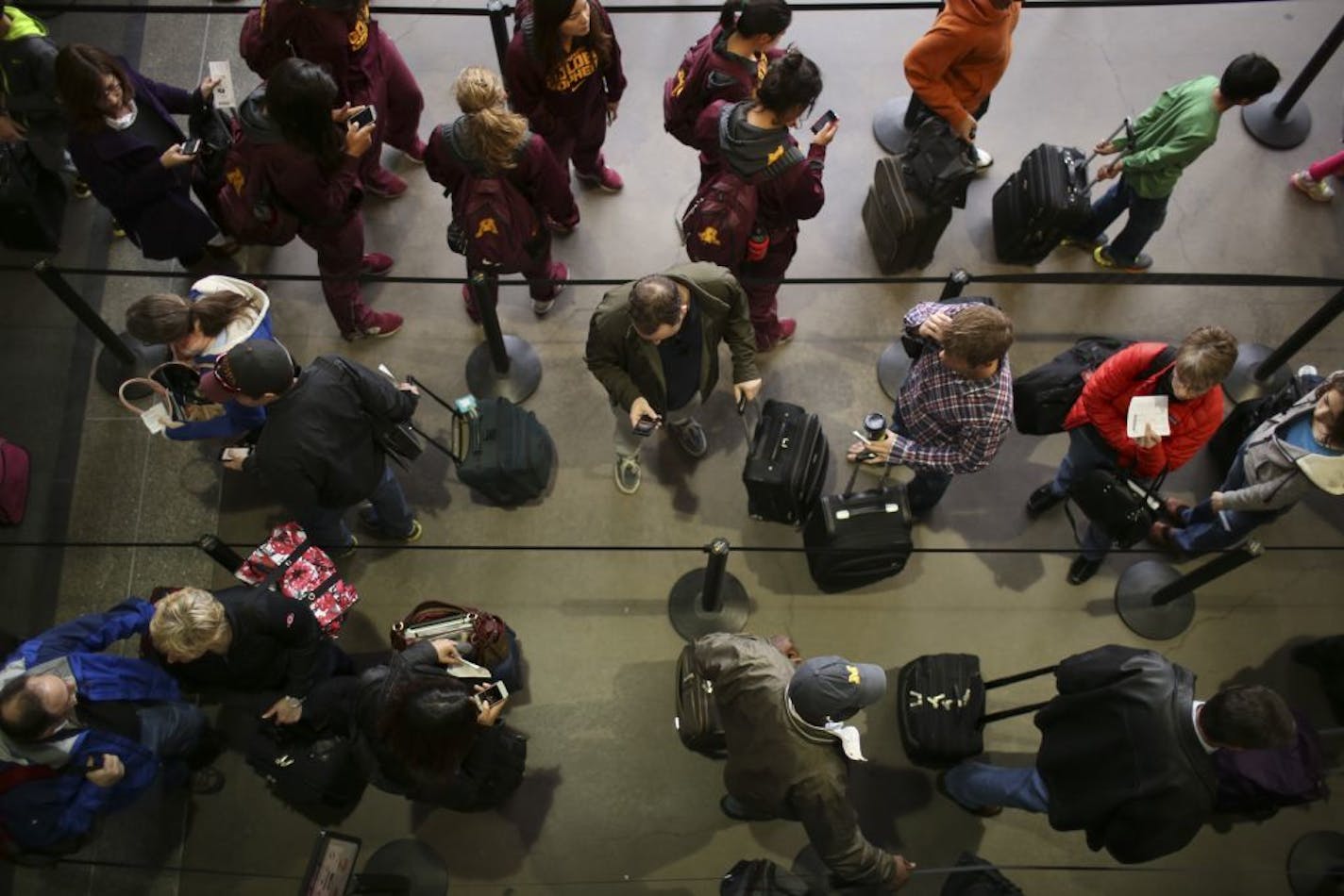 Air travelers waited in line to go through TSA security screening at the airport Wednesday afternoon.